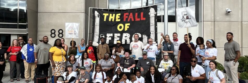 A crowd at FERC rallies under a Fall of FERC banner