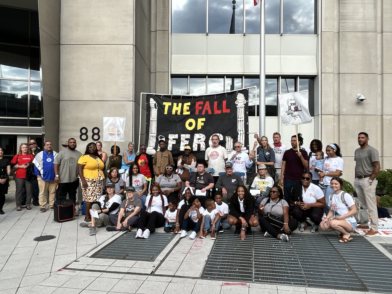 A crowd at FERC rallies under a Fall of FERC banner